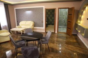 a waiting room with a table and chairs at Hotel Gold in Gyumri