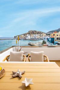 a table with two starfish on it with a view of the ocean at Olia Boutique Apartments in Karpathos Town