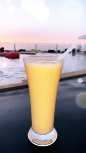 a glass of orange juice sitting on top of a table at Auberge Oualidia Dream in Oualidia
