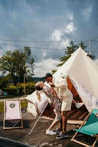 two people standing in front of a tent at Green Fields - Durbuy in Durbuy