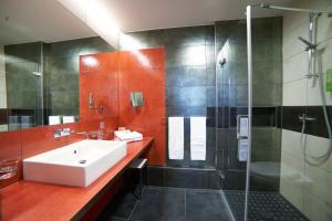 a bathroom with a sink and a shower at Hotel Maxlhaid in Wels