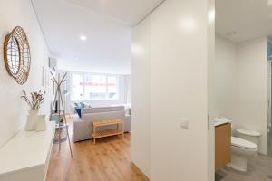 a white living room with a couch and a toilet at Oporto Palace Apartments in Porto +94 photos