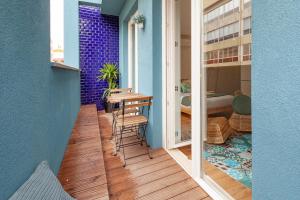 a small balcony with a table and a bedroom at Oporto Palace Apartments in Porto