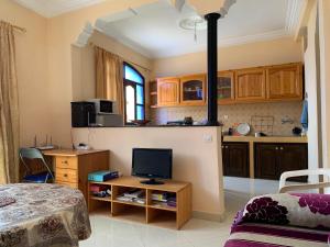 a room with a kitchen with a stove in it at Dar Amallay in Tamraght Oufella +9 photos