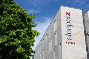 
a large building with a sign on it at Sleeperz Hotel Cardiff in Cardiff
