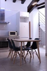 cocina con mesa de madera y sillas en Plaza Negrito Apartments, en Valencia