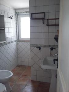 a bathroom with a toilet and a sink at Casa Vacanze "I Casali" in San Giovanni in Galdo