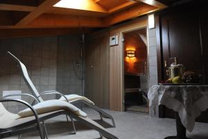 a bathroom with a chair and a shower at Hotel & Restaurant Pahor in Doberdò del Lago