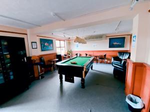 a living room with a pool table in it at Redwings Lodge Sawtry Huntington in Sawtry