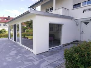 an extension to a house with sliding glass doors at Urbach 19 in Bad Waldsee