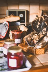 a counter with many different types of bread and jam at Chez Fred et Cécile in Verdilly +63 photos