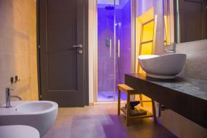 a bathroom with a sink and a tub and a toilet at Meduse Holiday IUNQ5361 in Cala Gonone +19 photos