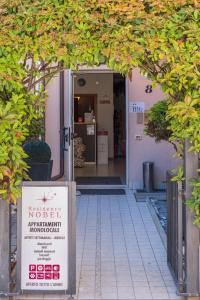 an entrance to a building with a sign in front of it at Residence Nobel in Rimini