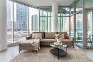 a living room with a couch and a table at GuestReady - Stunning View from Every Room in Dubai