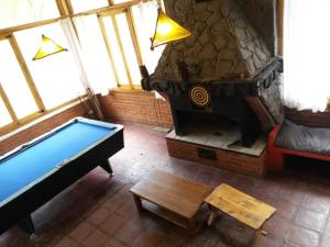 
a living room filled with furniture and a fire place at Rocas Amarillas in Valle Grande
