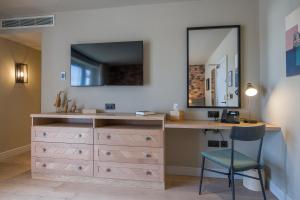 a bathroom with a vanity with a mirror and a desk at Sandburn Hall in York