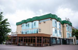 a large building with a green roof at Nalchik Hall in Nalchik