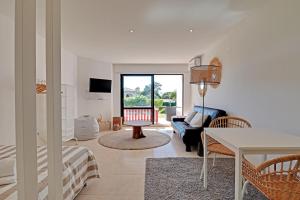 a living room with a couch and a table at Quinta do Lago Victory Village with Pool by Homing in Quinta do Lago