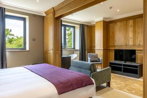 a hotel room with a bed and a television at Les Jardins de St Cloud in Saint-Cloud +75 photos