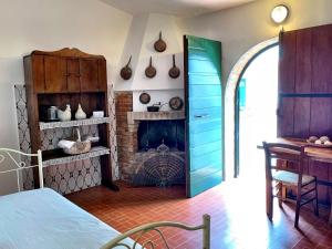 a room with a fireplace and a bed in a room at Il Forno Di Renzo in Castiglione della Pescaia