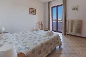 a bedroom with a bed and a view of the ocean at Residenza Nobel Appartamenti in Rimini