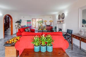 a living room with a red couch and a table at Umhlanga Beach House in Durban