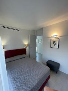 a small bedroom with a bed and a chair at Casa Plauto SUITE senza cucina without kichen in Bellaria-Igea Marina