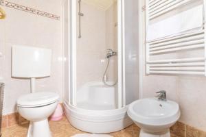 a bathroom with a toilet and a shower and a sink at Apartmani Nadia in Punat +11 photos