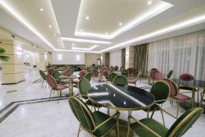a meeting room with tables and chairs in a building at Hotel Diamantidis in Myrina