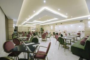 a restaurant with tables and chairs in a room at Hotel Diamantidis in Myrina