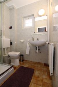 a bathroom with a toilet and a sink at Villa Galagonya I. II. in Balatongyörök