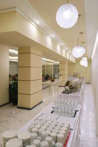 a room filled with lots of white dishes on display at Hotel Diamantidis in Myrina