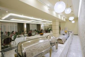 a salon with tables and chairs in a room at Hotel Diamantidis in Myrina