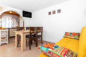 a living room with a couch and a table at Apartmani Nadia in Punat