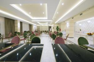 a large room with chairs and tables and a cafeteria at Hotel Diamantidis in Myrina