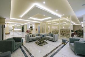 a large living room with couches and a table at Hotel Diamantidis in Myrina