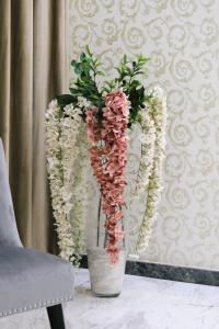 two vases with flowers in them on a table at Hotel Diamantidis in Myrina