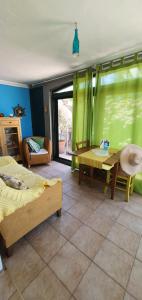 a room with two beds and a table and a window at Boutique Home Saltaragazza in Petrovac na Moru