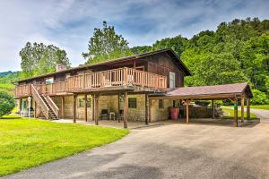 a large wooden house with a porch and a staircase at Lovely Richwood Respite Skiing, Biking, Climbing in Richwood
