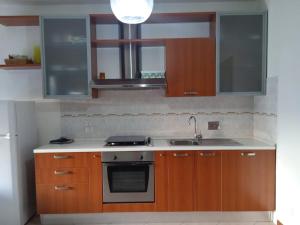 eine Küche mit Holzschränken und einem Waschbecken in der Unterkunft appartamento panoramico in Perugia