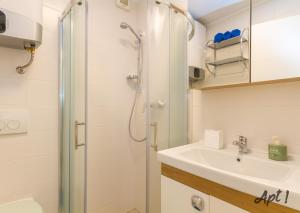 a bathroom with a shower and a sink at Apartments Kolenc in Portorož