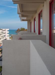 a balcony of a building with a view of the ocean at Hotel Nobel in Rimini