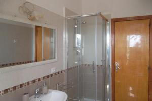 a bathroom with a shower and a sink and a mirror at maison jolie - Agropoli da vivere- in Agropoli +18 photos