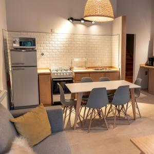 a kitchen with a table and chairs in a kitchen at BOG Norway - Departamentos Céntricos in Villa La Angostura