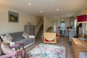 a living room with a couch and a table at Lyth Valley View at Broom Bank in Brigsteer