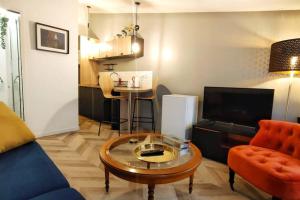 a living room with a couch and a coffee table at Votre Escale - Calliopé in Niort