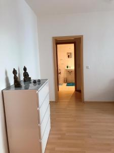 a kitchen with a counter with two statues on it at Sueños Apartment in Magdeburg