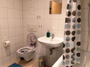 a small bathroom with a toilet and a sink at Sueños Apartment in Magdeburg