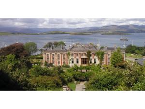 a large building in front of a body of water at Bru Na Pairc B&B in Bantry