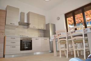 a kitchen with a table and chairs and a fireplace at TERESA HOLIDAY in Sarroch